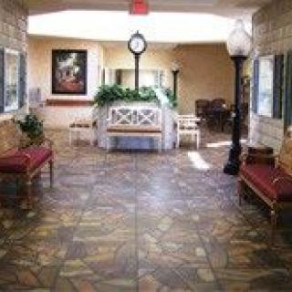 A well-decorated lobby area with seats and a central clock.
