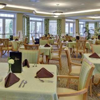 An elegant dining room with neatly arranged tables and chairs.