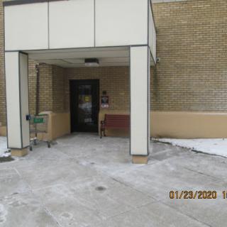 Entrance of a building covered in snow.