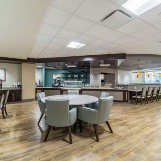 A modern dining area with a bar counter and seating arrangements.