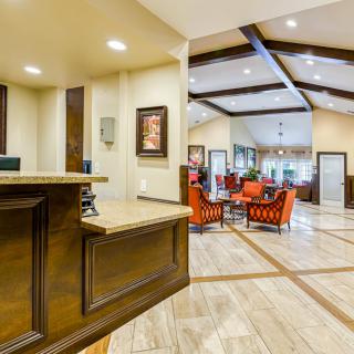 A modern hotel lobby with a spacious reception area and comfortable seating.