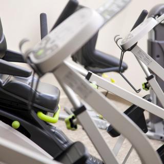 Close-up view of stationary bikes in a gym setting.