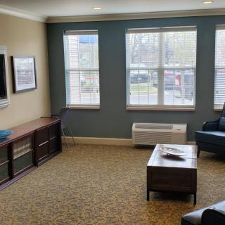 A cozy living room with a sofa, coffee table, and television.