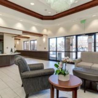 A modern lobby area with comfortable seating and a reception desk.