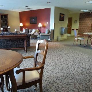 A spacious lounge area with comfortable seating and warm lighting.
