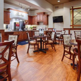 Cozy dining area with wooden floors and a coffee station.