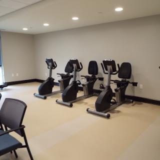 A clean and modern workout space featuring multiple recumbent bikes.