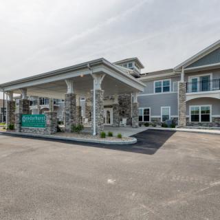 A modern building with a grand entrance and covered driveway.