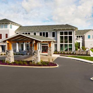A modern residential building with a welcoming entrance and landscaped surroundings.