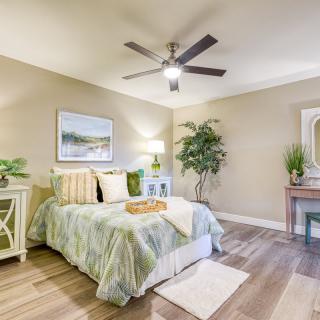 A stylish bedroom with elegant decor, featuring a comfortable bed, indoor plants, and tasteful artwork on the walls.