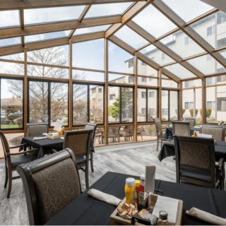 A bright, modern dining area with a glass roof offering a pleasant view.