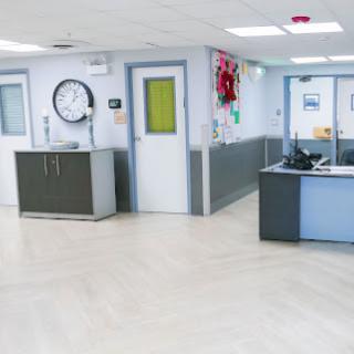 A clean and modern hospital reception area with a waiting space.