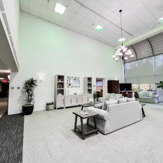 A spacious modern living room with comfortable seating and stylish decor.