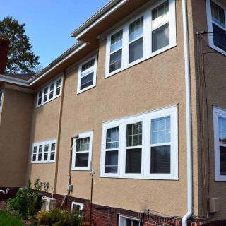 Exterior view of a residential building with multiple windows.
