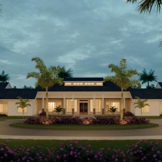 A well-lit house exterior with palm trees at dusk.