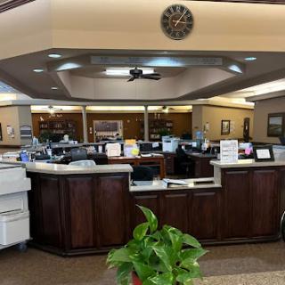 A view of a reception area in a medical facility, featuring desks and seating arrangements.