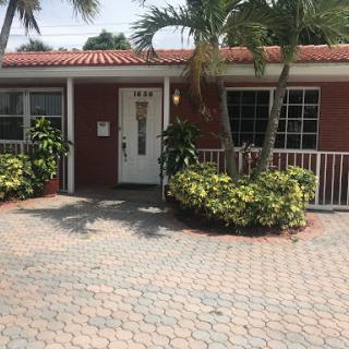A charming residential home with a landscaped front yard and paved driveway.