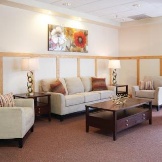 A cozy living room setting featuring comfortable seating and decorative elements.
