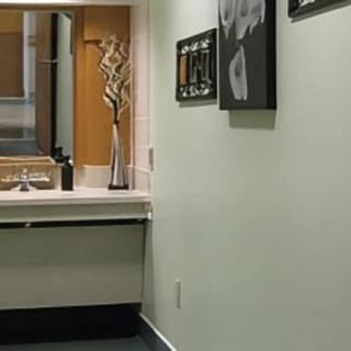 A modern bathroom interior with a sink, mirror, and decorative elements.