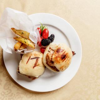 A plate of grilled sandwiches, a side of fries, and fresh berries.
