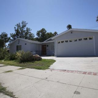A single-story suburban house with a driveway and attached garage.
