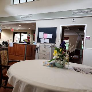 A welcoming lobby area featuring a beautifully arranged flower centerpiece on a table.