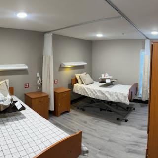 A spacious and modern hospital patient room designed for comfort and care.