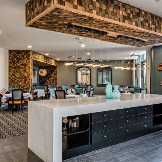 A modern kitchen and dining area with stylish decor and ample lighting.