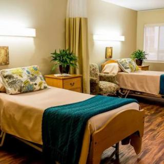 A well-appointed hospital room with two comfortable beds and soft lighting.