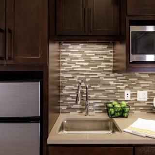 Modern kitchen with a stylish backsplash and contemporary appliances.