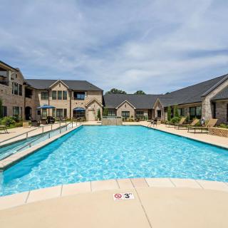 A serene view of a swimming pool in a residential apartment complex.