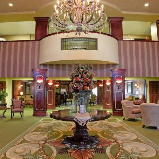 A luxurious hotel lobby with elegant furnishings and a grand chandelier.