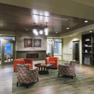 A modern lobby featuring comfortable seating and a cozy fireplace.
