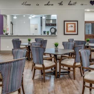 A modern and well-decorated dining area with multiple tables and chairs arranged neatly.