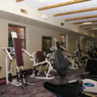 A gym filled with various exercise machines for strength training.