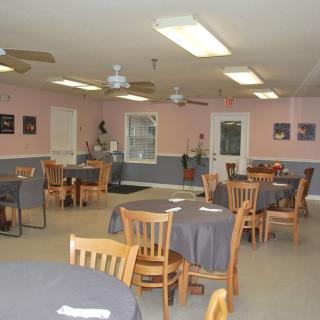 An empty restaurant interior with neatly arranged tables and chairs.