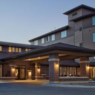 Exterior view of a hotel entrance during evening hours.