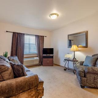 A cozy living room with comfortable seating and a television.