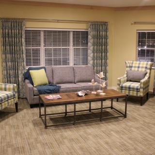 A cozy living room with a sofa, armchairs, and a coffee table.