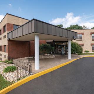 A modern building entrance with landscaped surroundings.