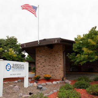 A view of a building with the American flag flying overhead, showcasing its welcoming exterior and signage.