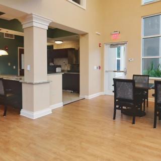 A modern dining area with wooden flooring and stylish furniture.