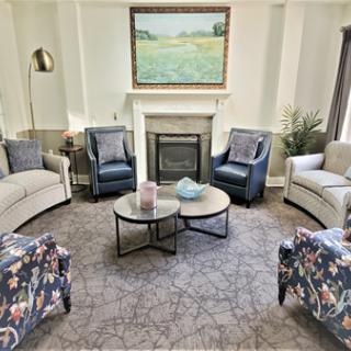 A cozy living room with a fireplace and comfortable seating arrangements.