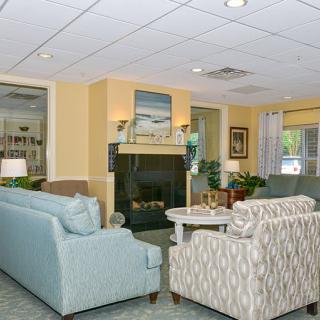 A cozy living room with a fireplace, sofas, and stylish decor.
