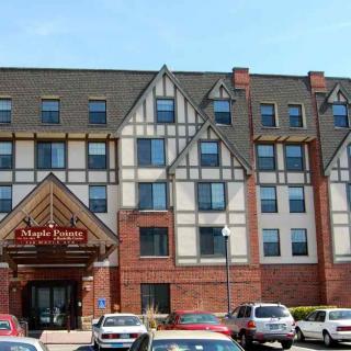 A hotel building with Tudor-style architecture and adjacent parking area.
