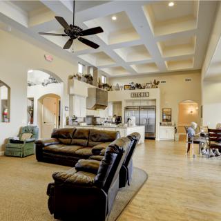 A spacious open-concept living area with modern furnishings and a large kitchen.