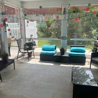 A cozy patio with comfortable seating and a view of the garden.