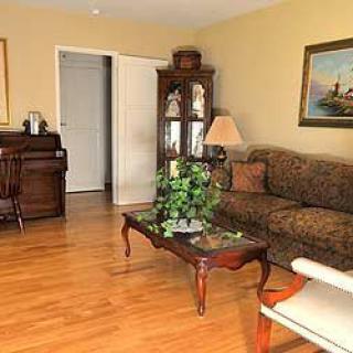 A cozy living room with a sofa, coffee table, and wooden furnishings.