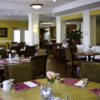A cozy restaurant dining area with tables and chairs set for service.