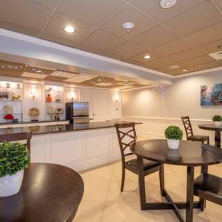 A modern cafe space featuring tables and chairs, perfect for a cozy breakfast or casual meeting.
